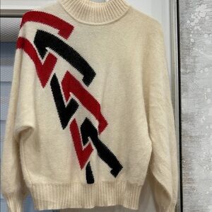 Chic Cream Sweater with Red and Black Zigzag Design